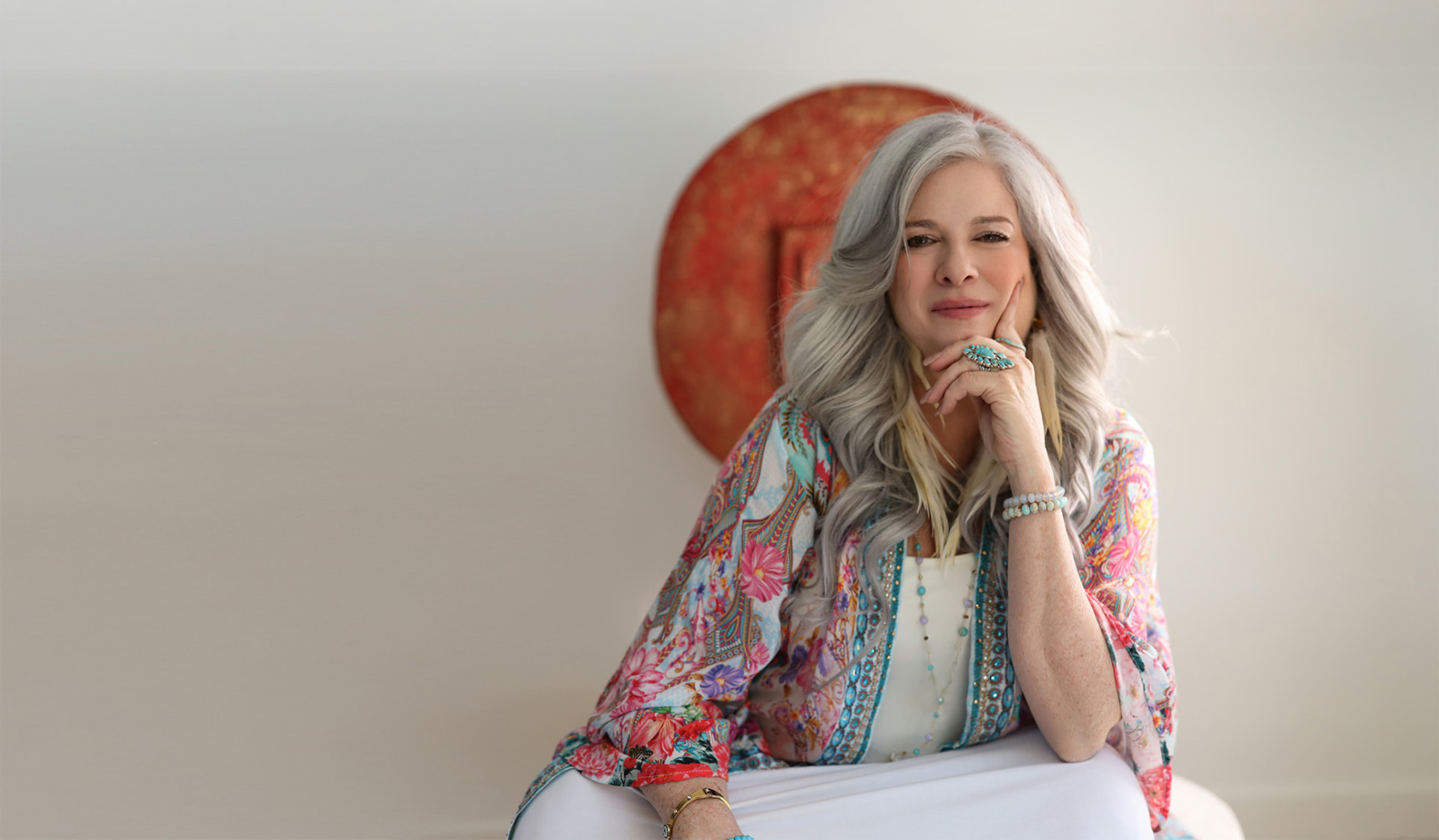 Elizabeth seated in warm, colorful light
